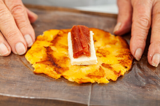 Senior woman preparing a traditional dish from el Valle del Cauca in Colombia called aborrajado