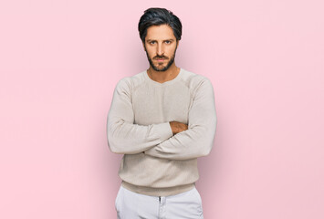 Young hispanic man wearing casual clothes skeptic and nervous, disapproving expression on face with...