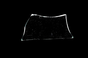 glass fragments in isolation on a black background. damaged window. damaged object