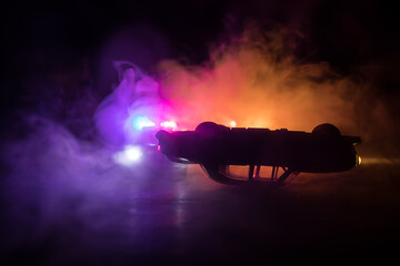 Police car chasing a car at night with fog background. 911 Emergency response police car speeding...