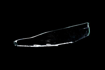 glass fragments in isolation on a black background. damaged window. damaged object
