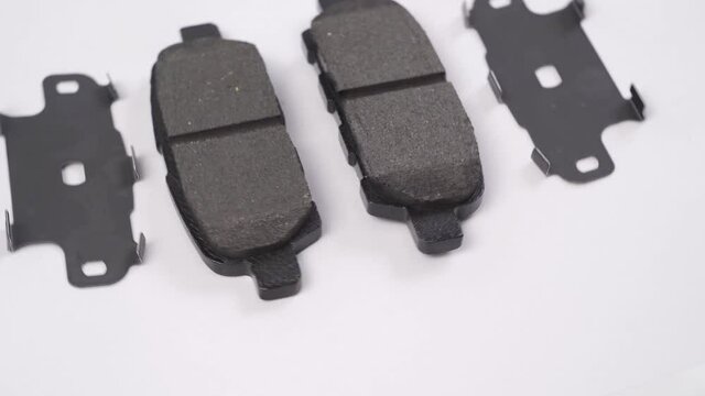 The brake pad rotates against a white background. part of the braking system.