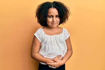 Young little girl with afro hair wearing casual clothes with hand on stomach because indigestion, painful illness feeling unwell. ache concept.