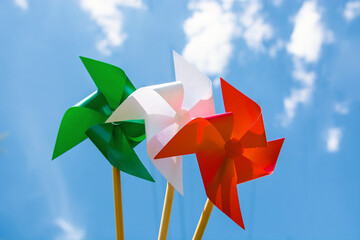 paper windmill in italian flag color, national Italy background 