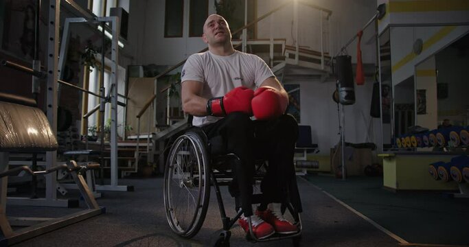 Tired handicapped boxer resting in gym