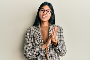 Young chinese woman wearing business style and glasses clapping and applauding happy and joyful,...
