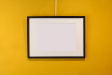 Mockup - framed picture hanging on the wall