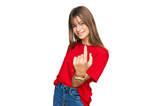 Teenager caucasian girl wearing casual red t shirt beckoning come here gesture with hand inviting welcoming happy and smiling