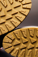 fluted sole of winter brown leather men's shoes on a black background.