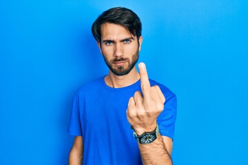 Young hispanic man wearing casual clothes showing middle finger, impolite and rude fuck off...