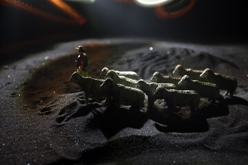 Sheep in the farm. Farm (village) life concept. Decorative toy figures at night. Selective focus