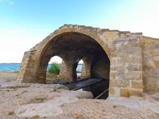 Magnificent old stone wash house from the 18th century called wash house of contagious on the edge of the Berre pond in Saint-Chamas in Provence in France