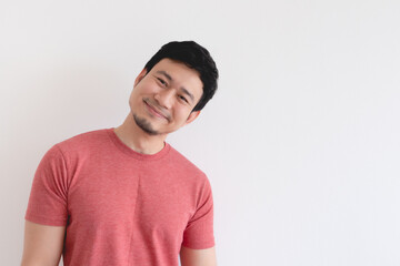 Smile face of Happy Asian man in red t-shirt isolated on white background.