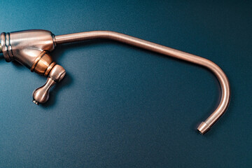 Brass tap to filter drinking water on a black background.