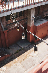 Urban alley with light bulbs strung across
