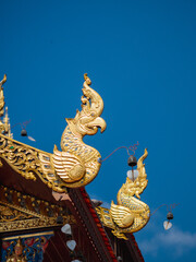 Fototapeta na wymiar Golden wood carving art in Lanna style decorated in the temples.