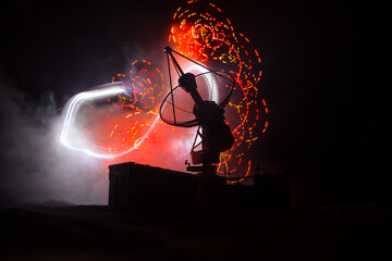 Silhouettes of satellite dishes or radio antennas against night sky. Space observatory or Air...