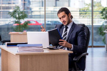 Fototapeta premium Young businessman employee working in the office