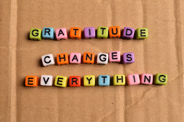 Colorful alphabet beads with phrase GRATITUDE CHANGE EVERYTHING.