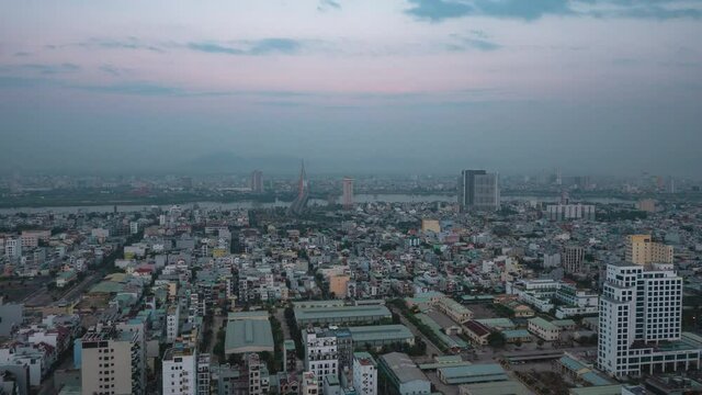 Cinematic time-lapse view of an industrialized city in Asia from night to day.