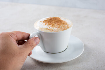 A closeup view of a cup of black coffee, on the left side of the frame.