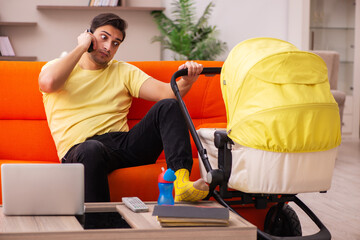 Young man looking after new born at home