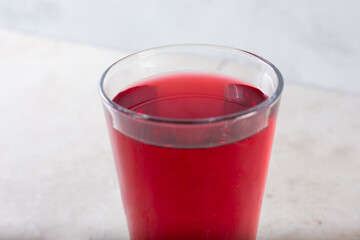 A closeup view of a glass of cranberry juice.