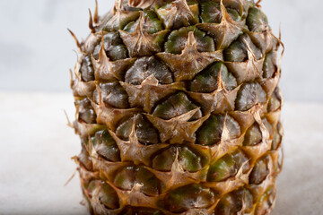 A closeup view of the outer skin of a ripe pineapple.