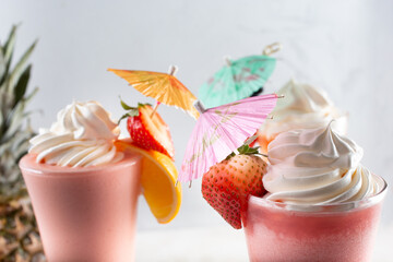 A view of paper drink umbrella garnishes decorating a selection of fruit smoothies.