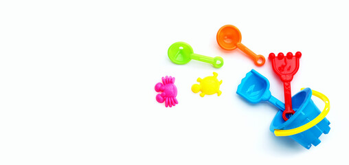 Plastic toys, shovel and bucket for sand on white background. Summer background concept