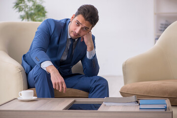 Young male employee waiting for business meeting