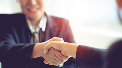 Fototapeta premium Negotiating business,Image business woman handshake,happy with work, business woman she is enjoying with her workmate. Deal Concept