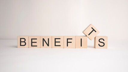The word benefits is written on wooden cubes on a light background. Business concept