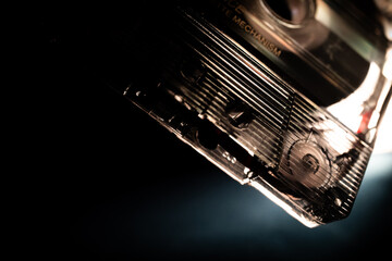 Minimalist Macro Closeup of Corner of See Through Cassette Tape on Black and Blue Backdrop