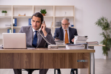 Two employees sitting at workplace