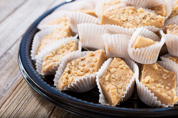 A view of a tray of Persian halva pastries, featuring nuts.