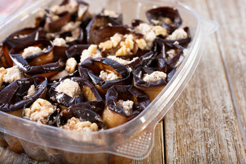 A view of a container of Armenian eggplant roll salad.