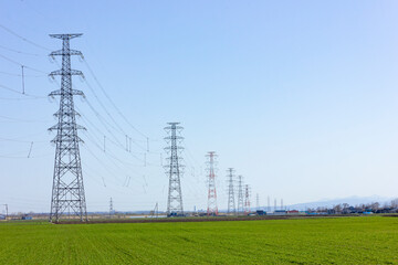 農地に立つ送電鉄塔