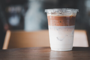 Iced latte coffee glass on wooden table.