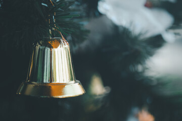 Christmas gold colour bell hanging on Christmas tree