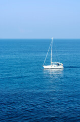 Fototapeta premium Sea view and white yacht without sails in the distance