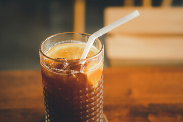 Glass of espresso mixed with orange juice and honey.