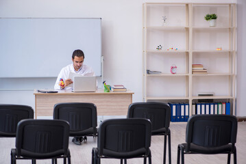 Young male doctor giving seminar in the classroom