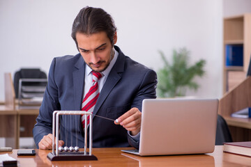 Young man businessman employee sitting in the office