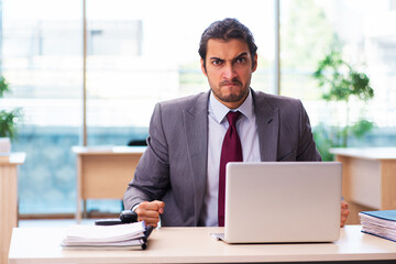 Young male employee working in the office