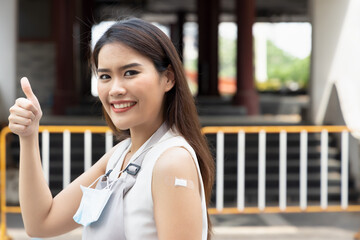 Reopening restaurant and catering business with vaccinated service worker giving thumb up, concept of frontline worker waitress inoculation, herd immunity, successful vaccine roll-out program - obrazy, fototapety, plakaty