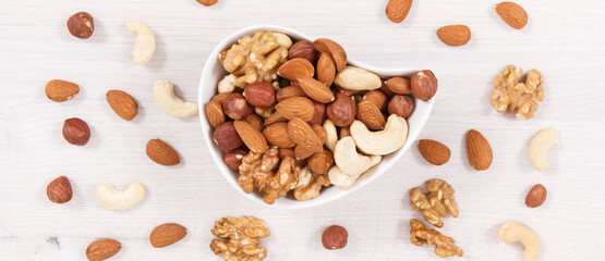 Various nuts and almonds as source healthy natural vitamins, nutritious eating concept