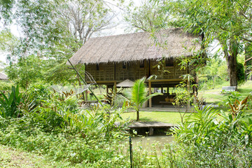 Fototapeta na wymiar Traditional Thai style wooden house surrounded with nature