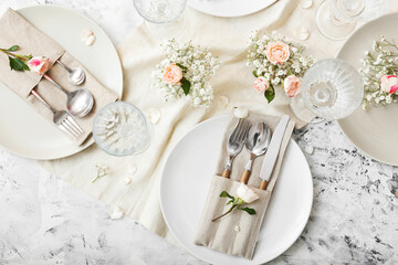 Beautiful table setting with floral decor on light background