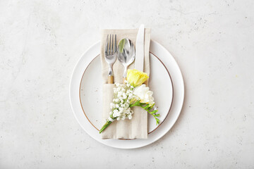 Beautiful table setting with floral decor on light background